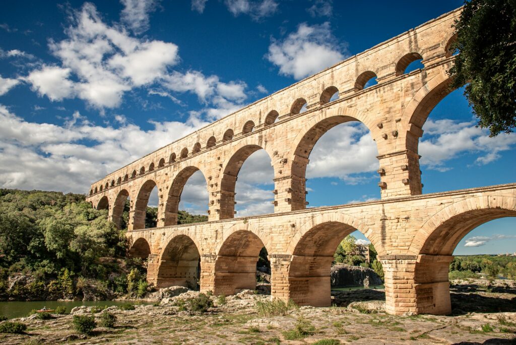 Explore aqueducts and ancient water transport systems and their importance in early civilizations.